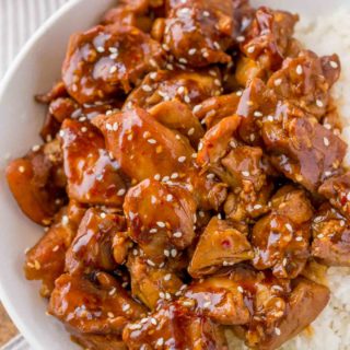 Skinny Sesame Chicken in bowl with rice.