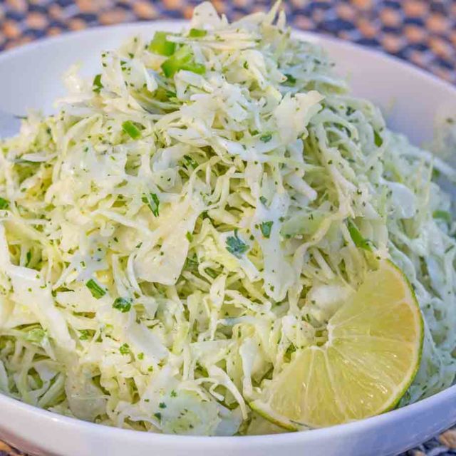 Creamy Cilantro Lime Slaw with jalapenos, greek yogurt and spices is the perfect zero point side dish or taco topper you will LOVE with your favorite Mexican recipes.