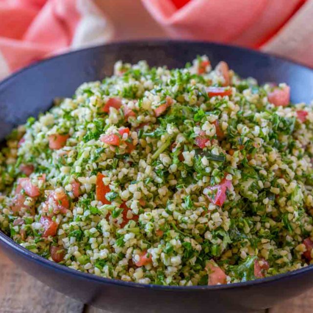 Tabouli Salad made with bulgur, tomatoes, mint, lemon and olive oil with lots and lots of fresh parsley. This is the perfect easy side dish for your favorite middle eastern cooking for just 3 smart points per serving.