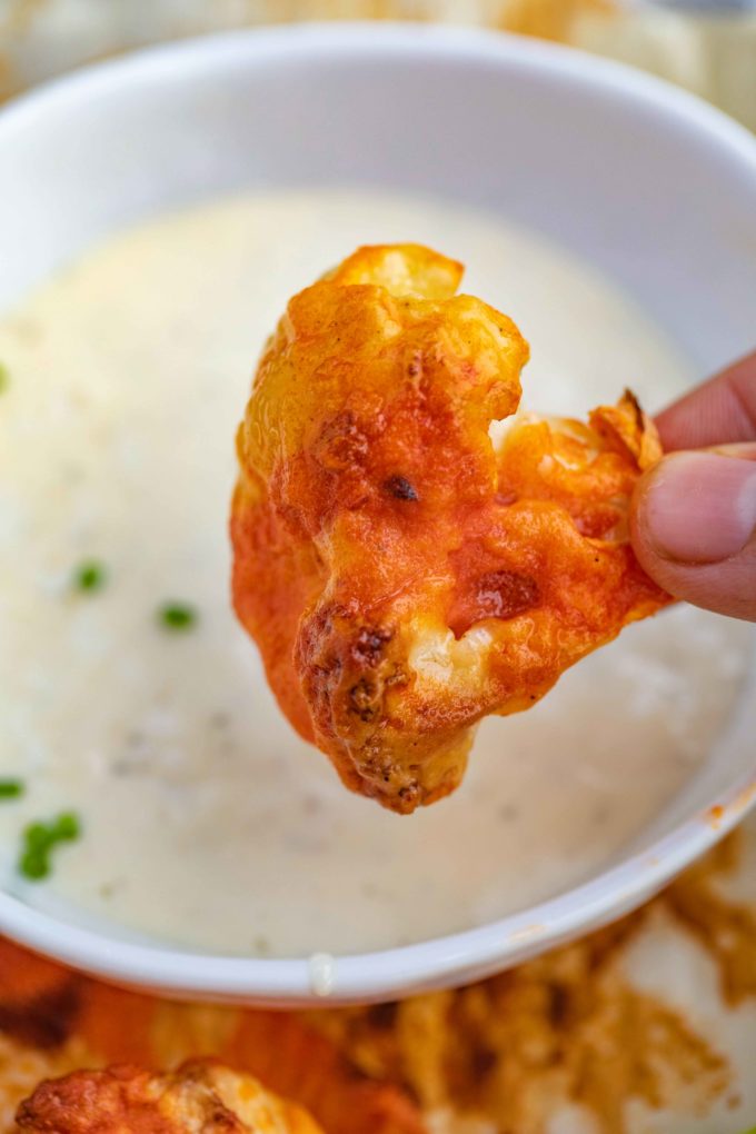 Buffalo Cauliflower being dipped in lowfat ranch dressing