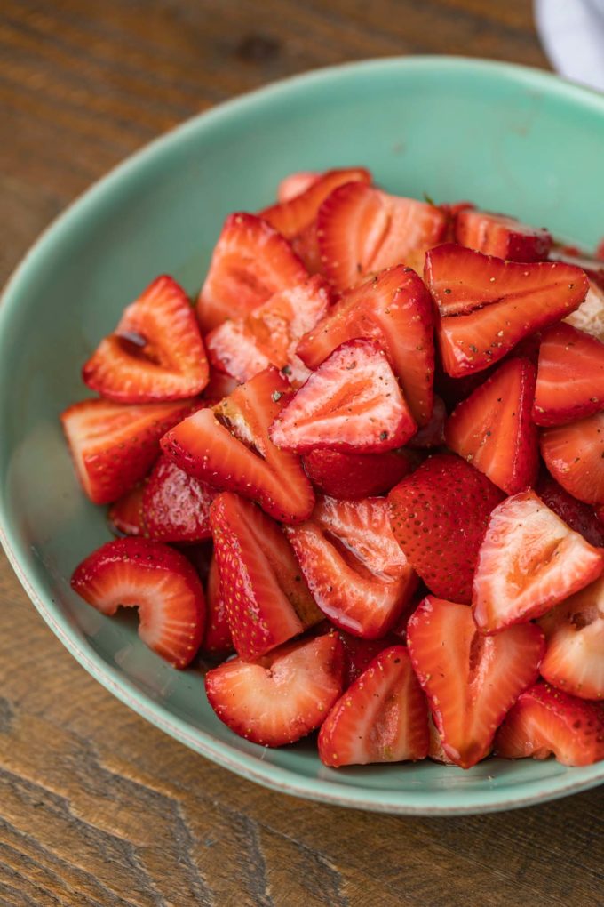 Balsamic Strawberries with black pepper in green bowl