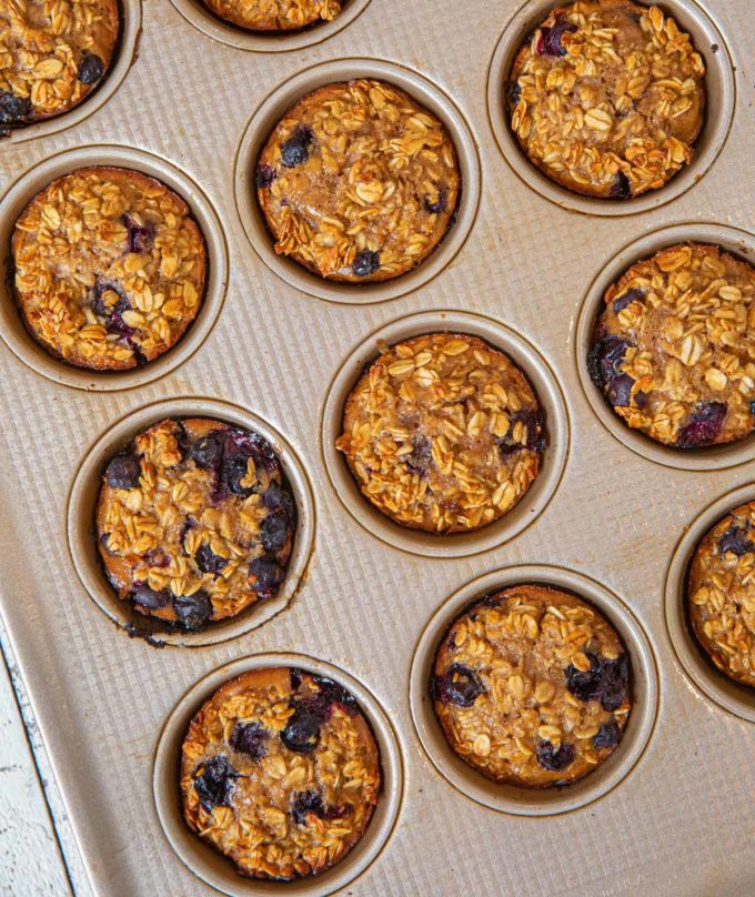 Muffin tin full of Blueberry Banana Baked Oatmeal Muffins