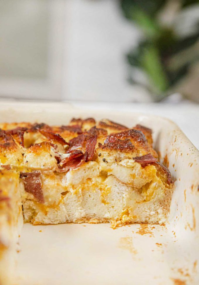 Healthy Breakfast Casserole with Turkey Bacon in baking dish with slice removed