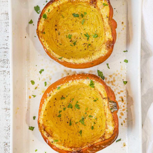 Roasted Acorn Squash in baking dish with parsley
