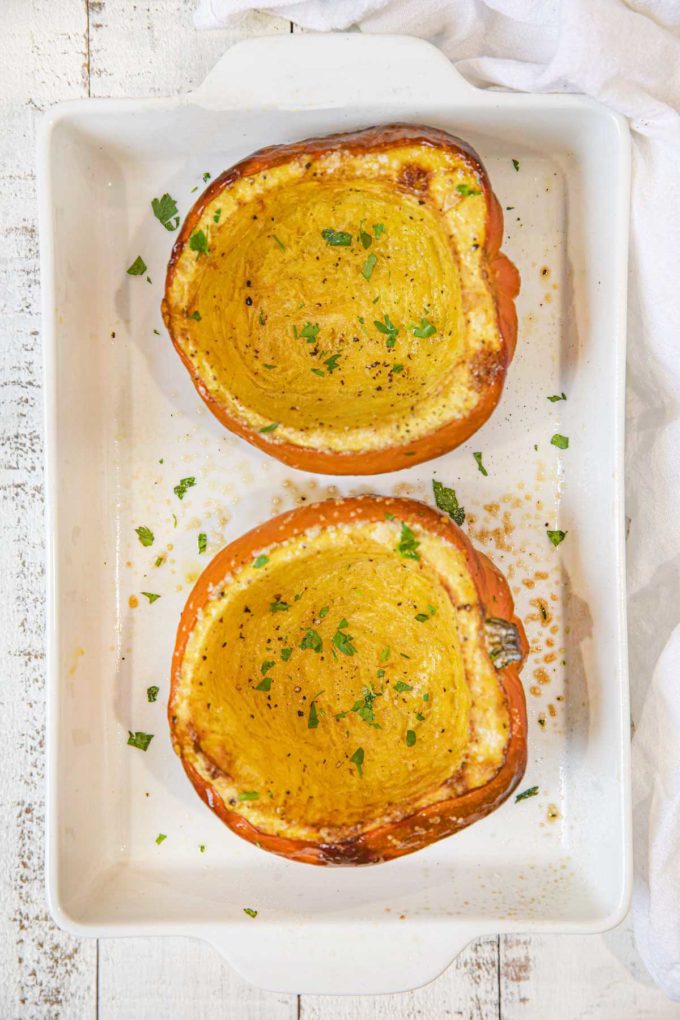 Roasted Acorn Squash in baking dish with parsley