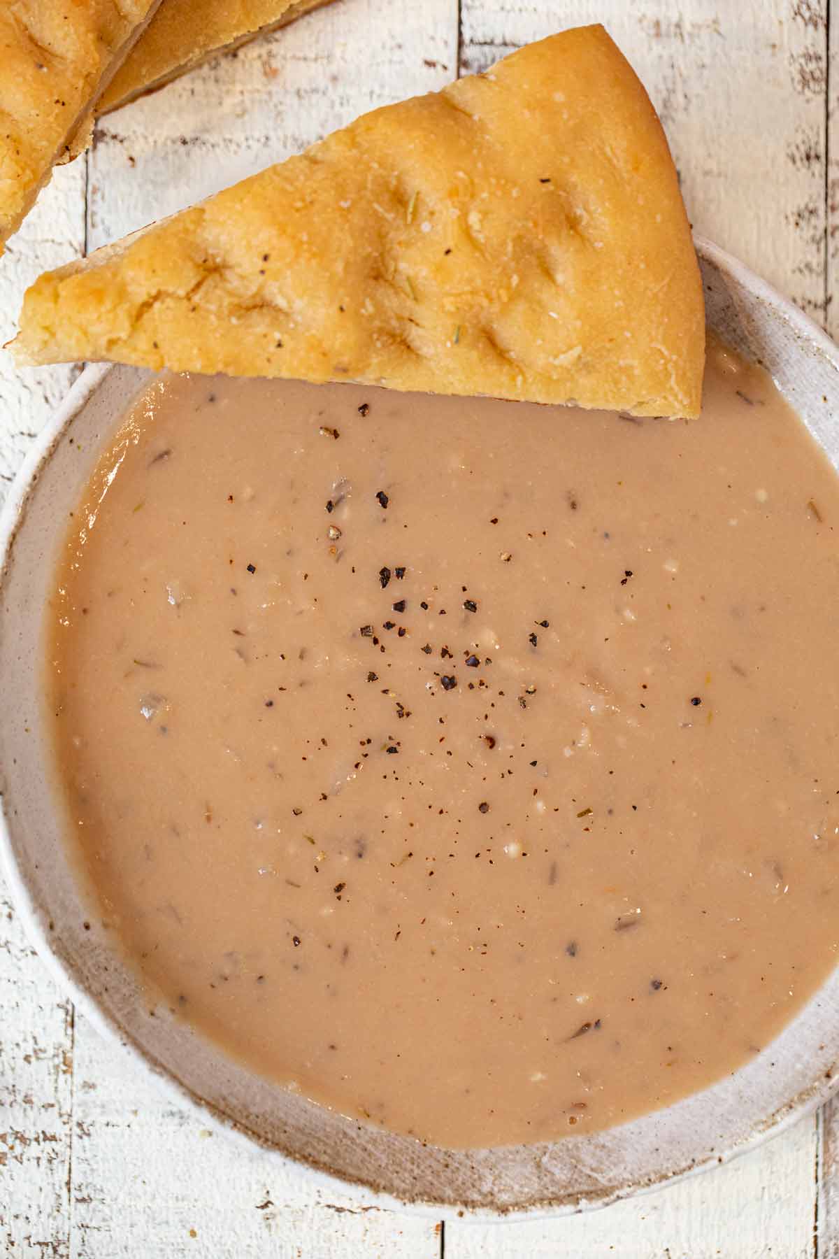 White Bean Soup in bowl with naan