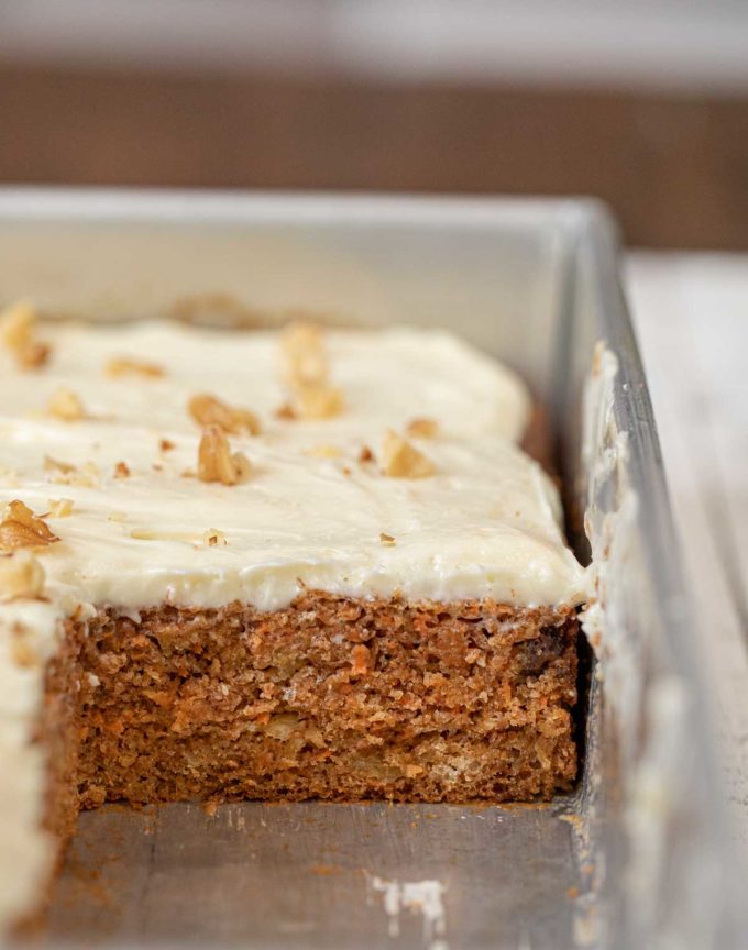 Whole Wheat Carrot Sheet Cake in sheet pan with slice removed