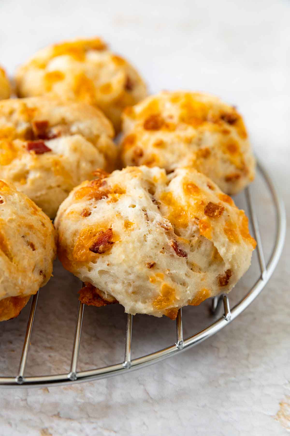 Yogurt Cheddar Bacon Biscuits on a cooling rack
