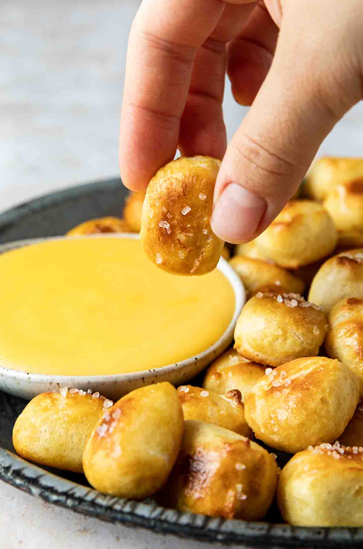 Easy Pretzel Bite being dipped into cheese sauce