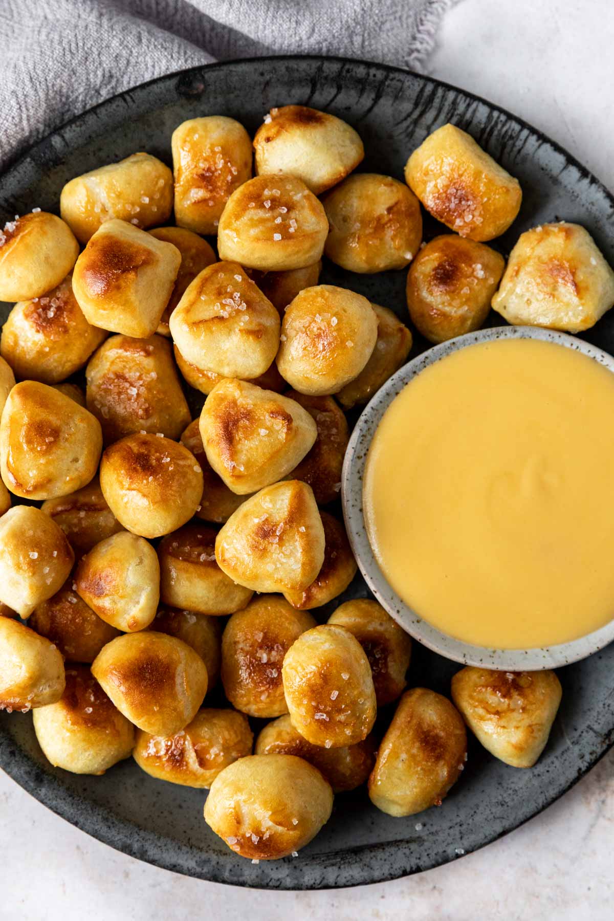 Easy Pretzel Bites in serving bowl with cheese sauce