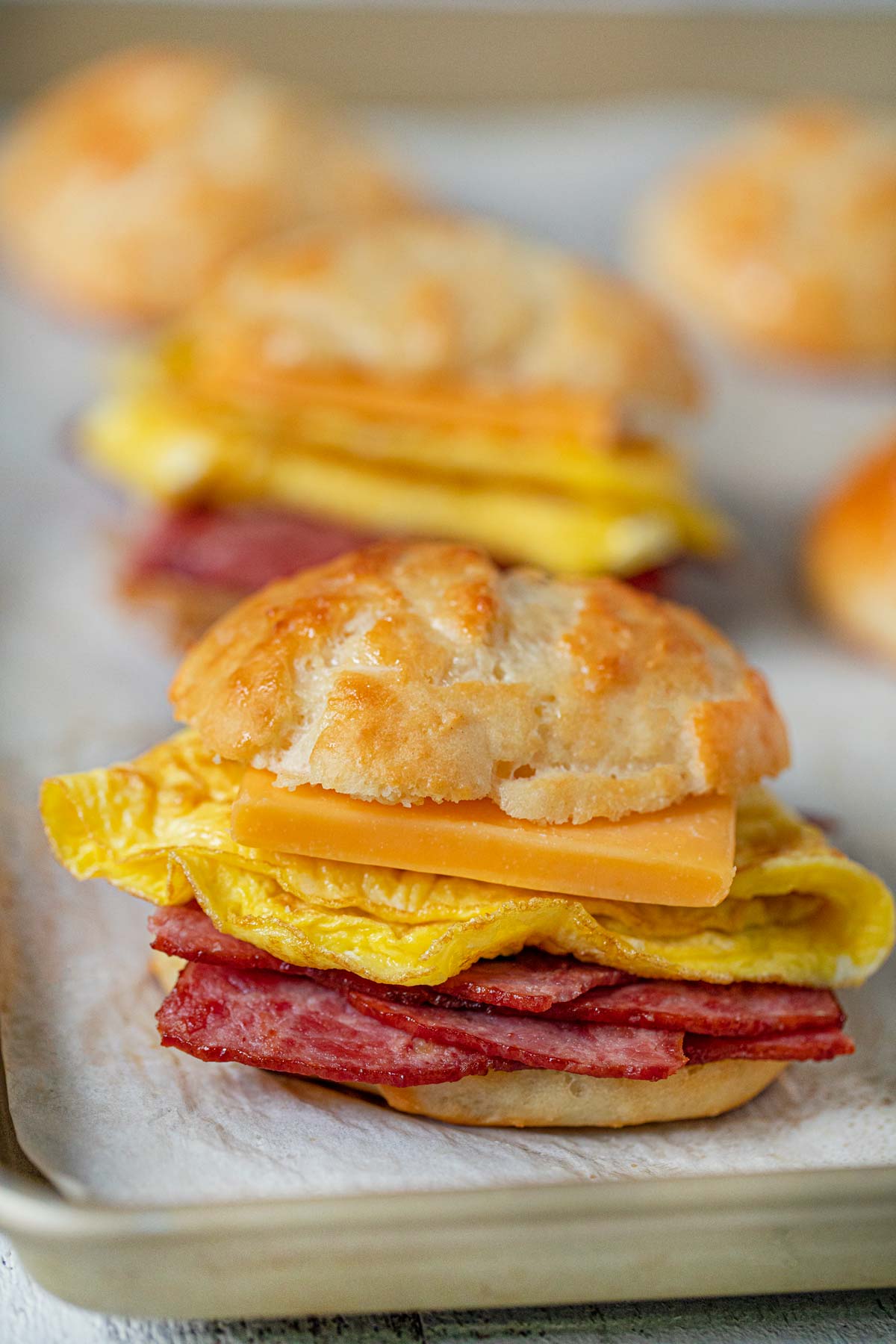 Healthy Bacon and Egg Cheese Biscuit Sandwiches on baking sheet