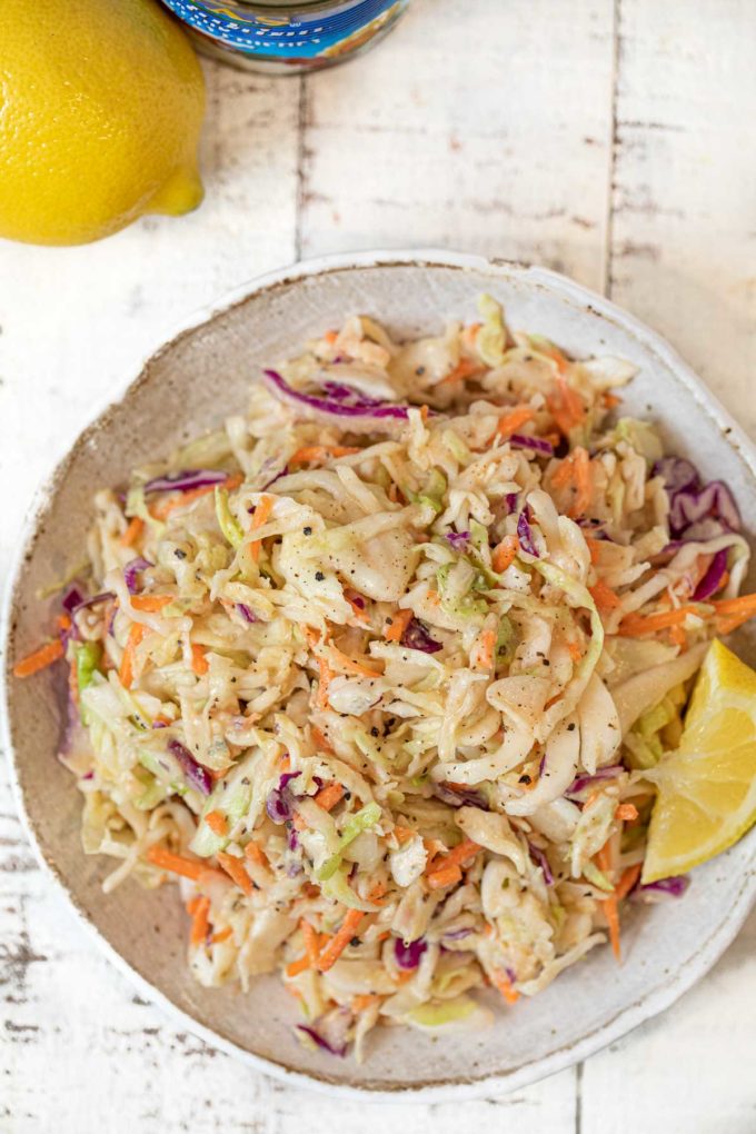 Hummus Slaw in bowl with lemon