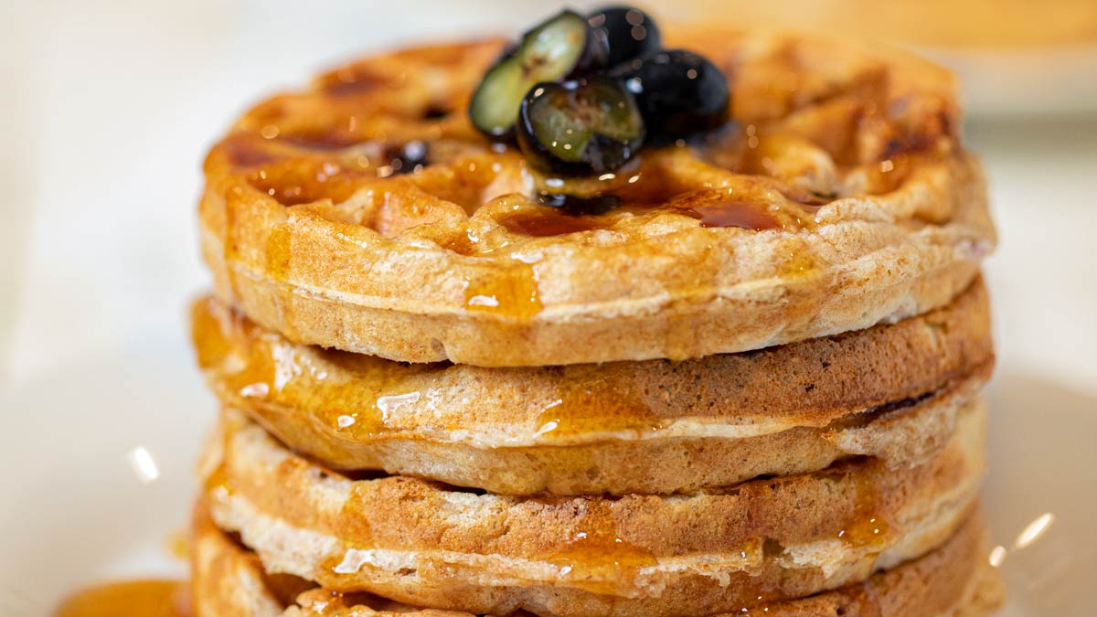 Whole Wheat Yogurt Blueberry Waffles on plate with syrup