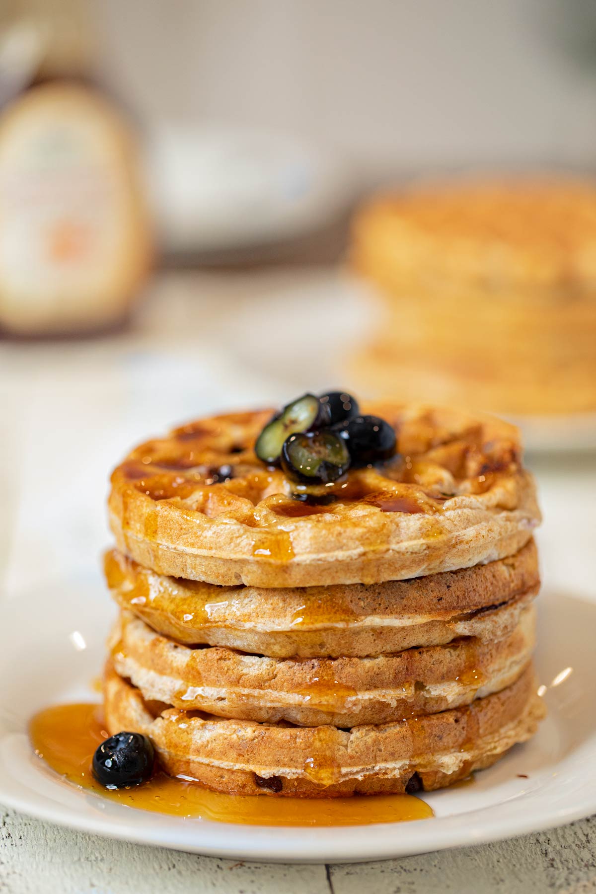 Whole Wheat Yogurt Blueberry Waffles on plate with syrup