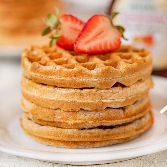 Yogurt Waffles in stack on plate topped with strawberries