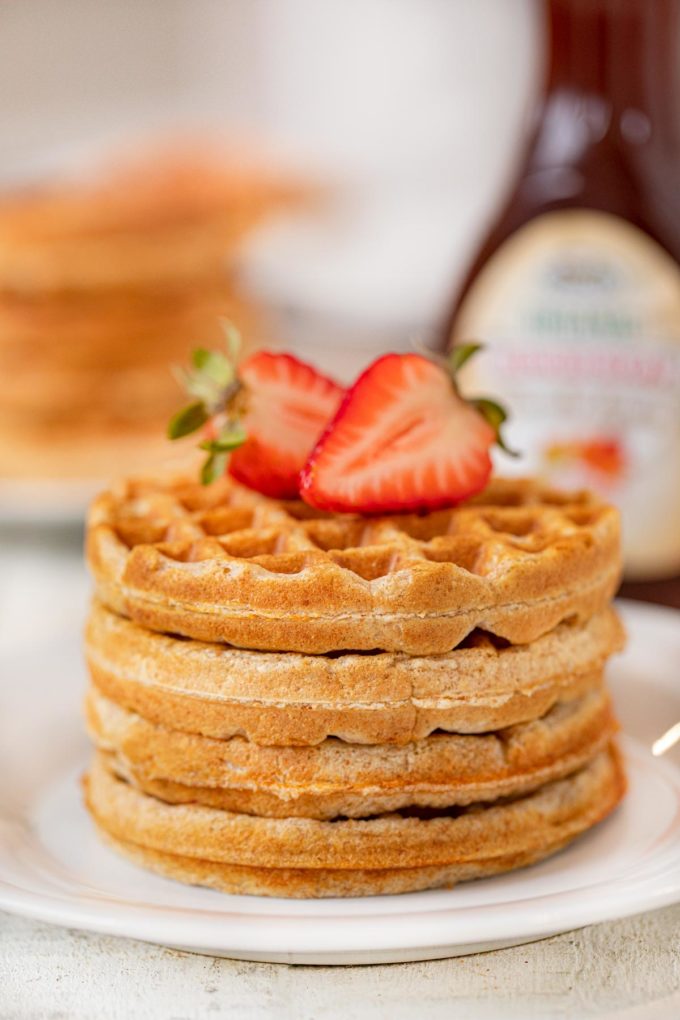 Yogurt Waffles in stack on plate topped with strawberries