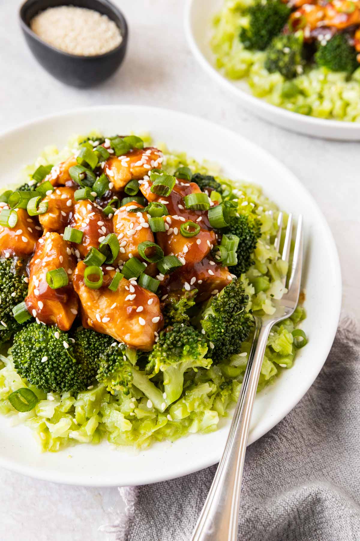 Sesame Chicken Broccoli Rice on plate with fork 