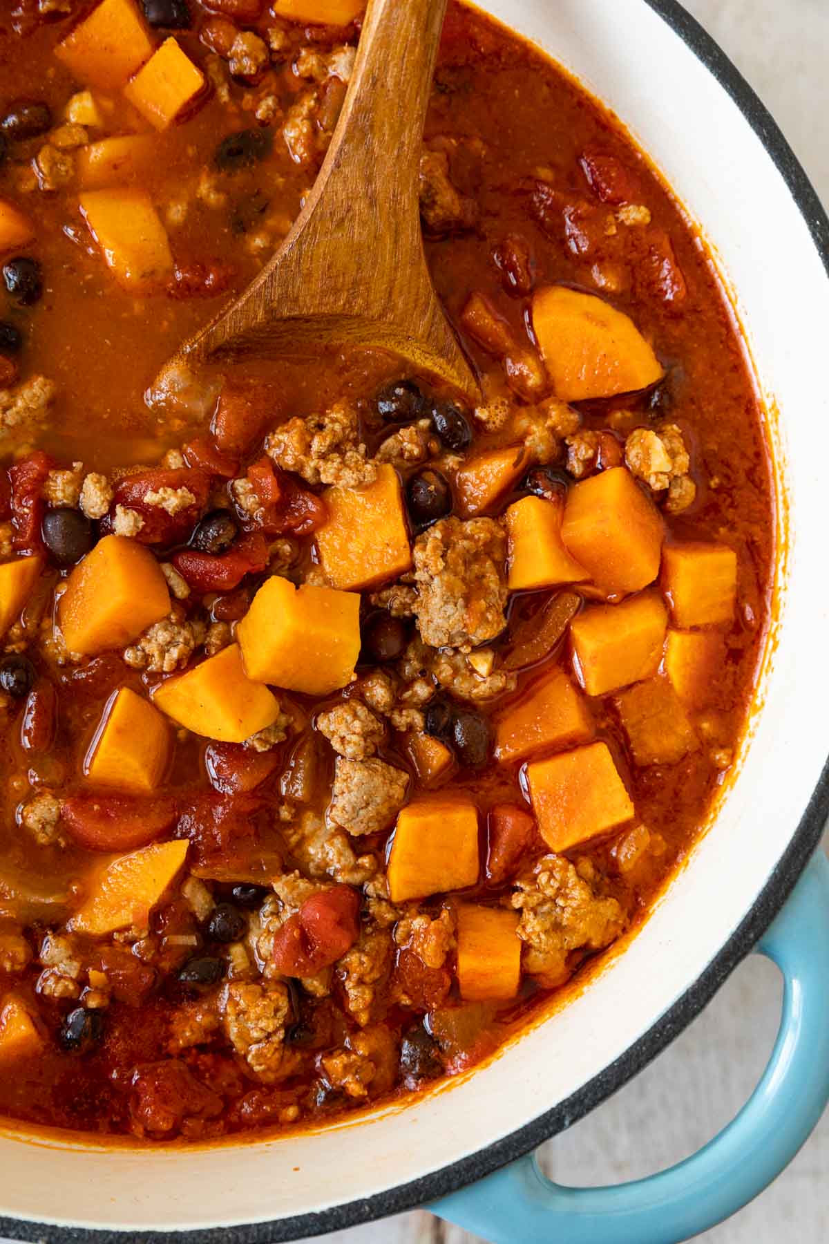 Turkey Sweet Potato Chili in pot with wooden spoon