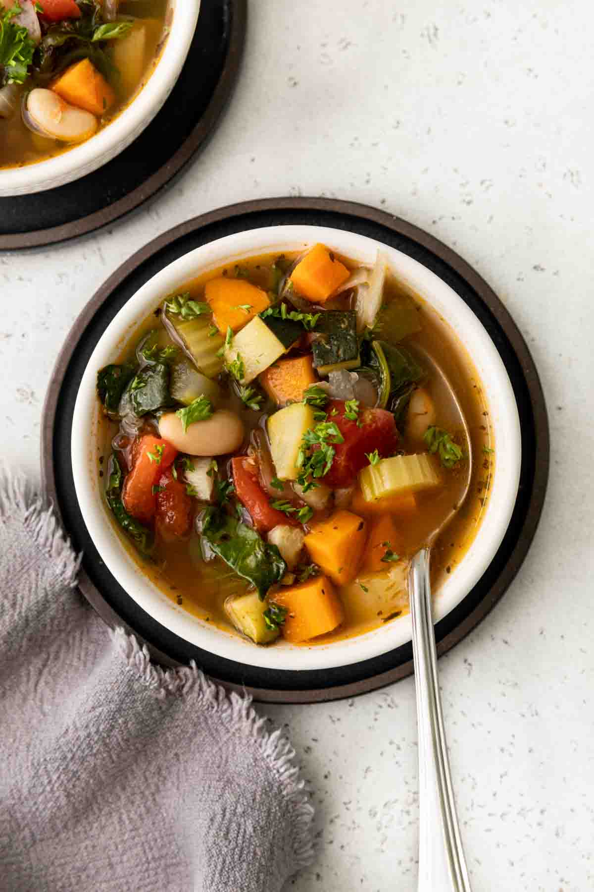 Tuscan Vegetable Soup in bowl with spoon