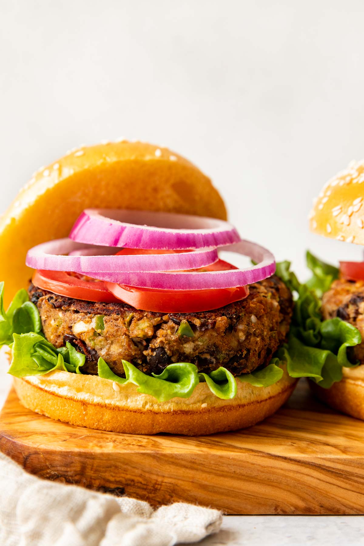 Black Bean Burger on bun with red onion and lettuce