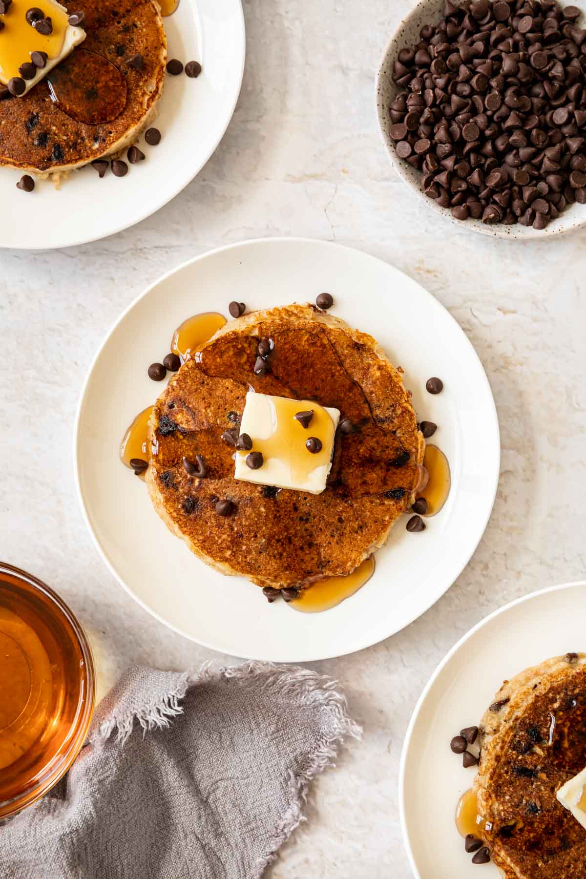 Chocolate Chip Pancakes on plates with bowl of chocolate chips