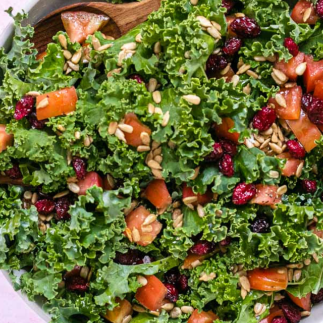 Kale Salad in bowl with wooden spoon