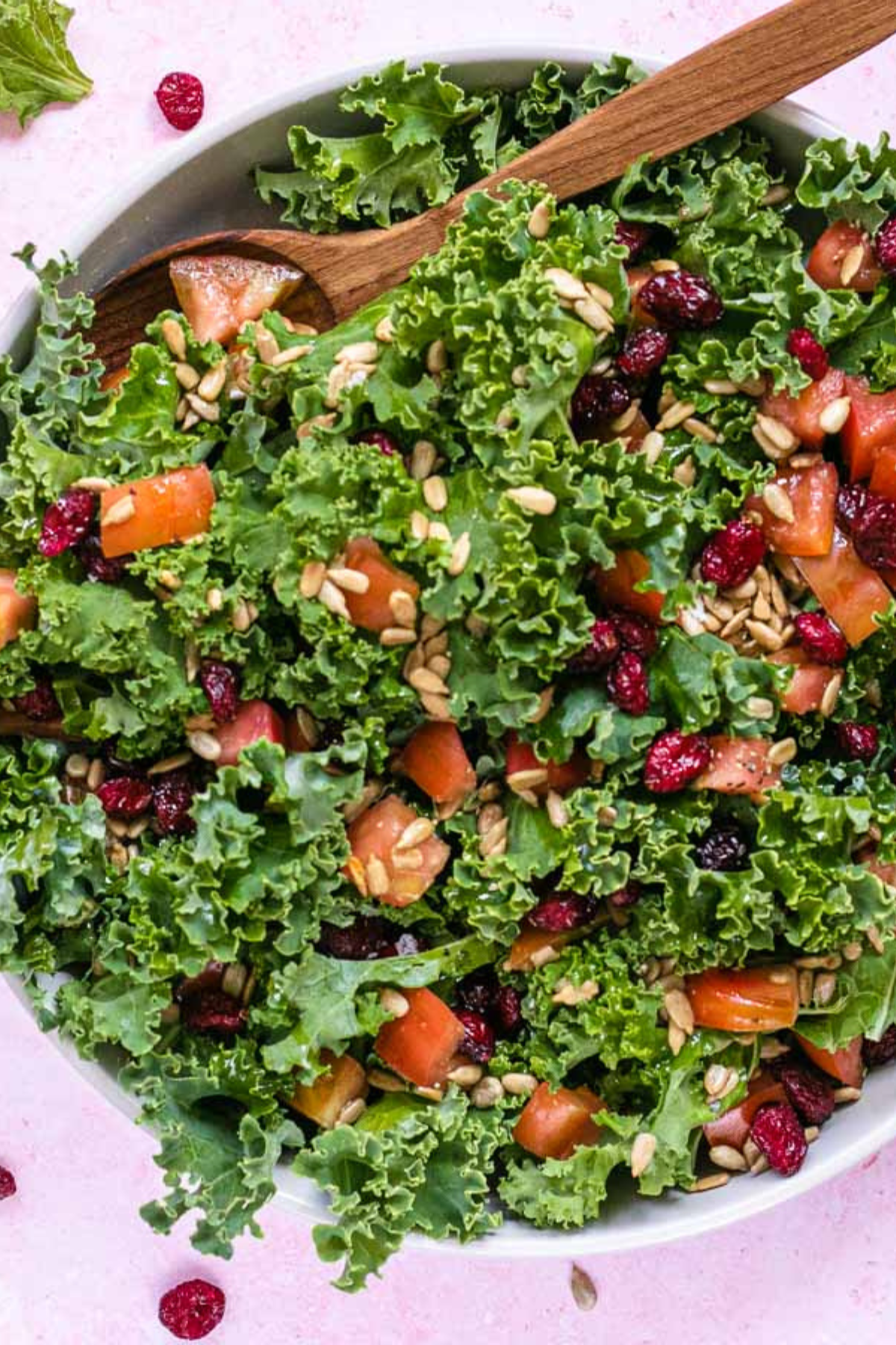 Kale Salad in bowl with wooden spoon