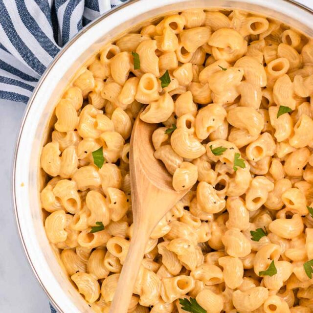 Healthy Macaroni and Cheese in a pot with wooden spoon
