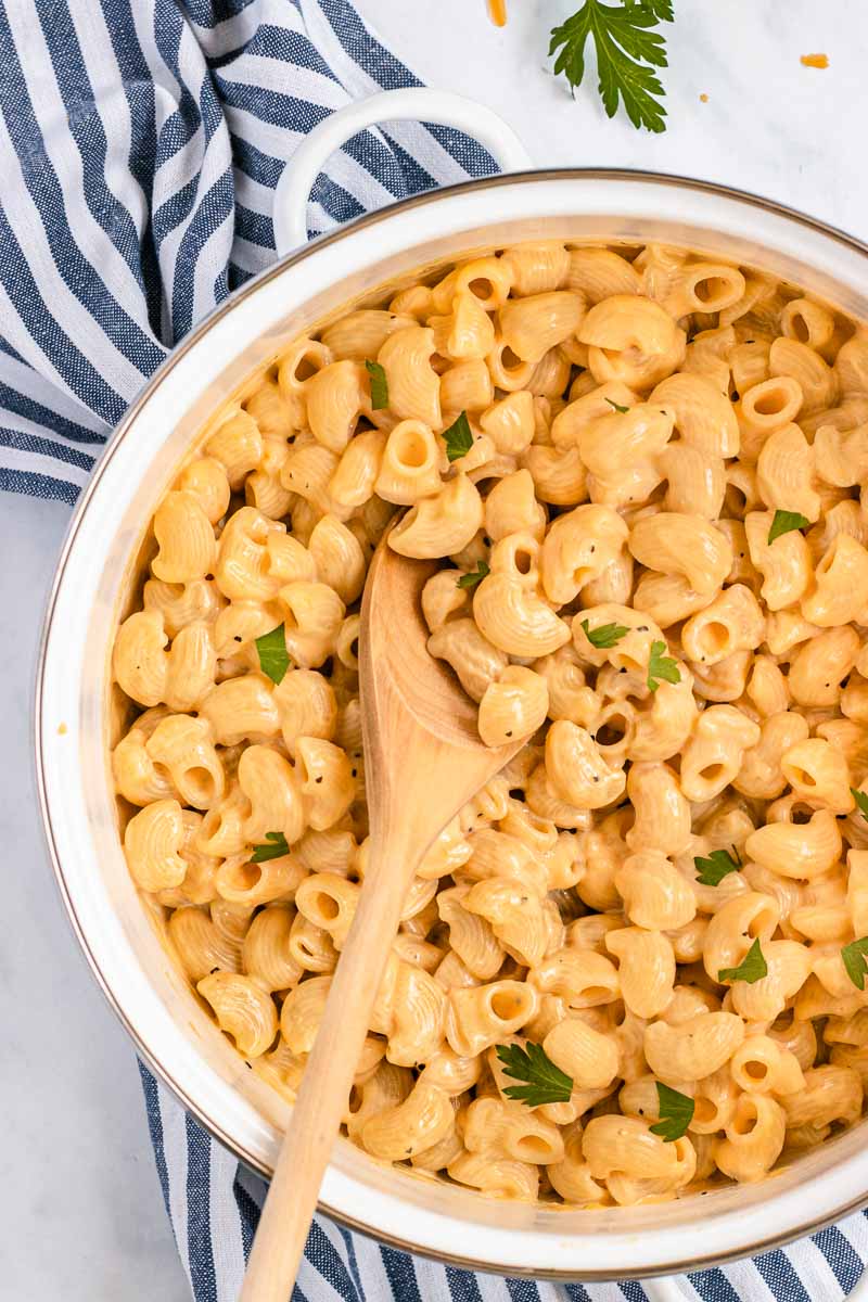 Healthy Macaroni and Cheese in a pot with wooden spoon