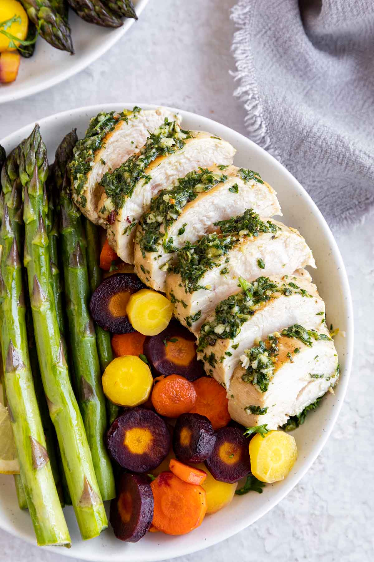 Roasted Chicken with Lemon Garlic Herb Sauce sliced on a plate