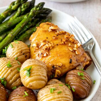 Roasted Garlic Chicken on plate with asparagus and hassel-beck potatoes