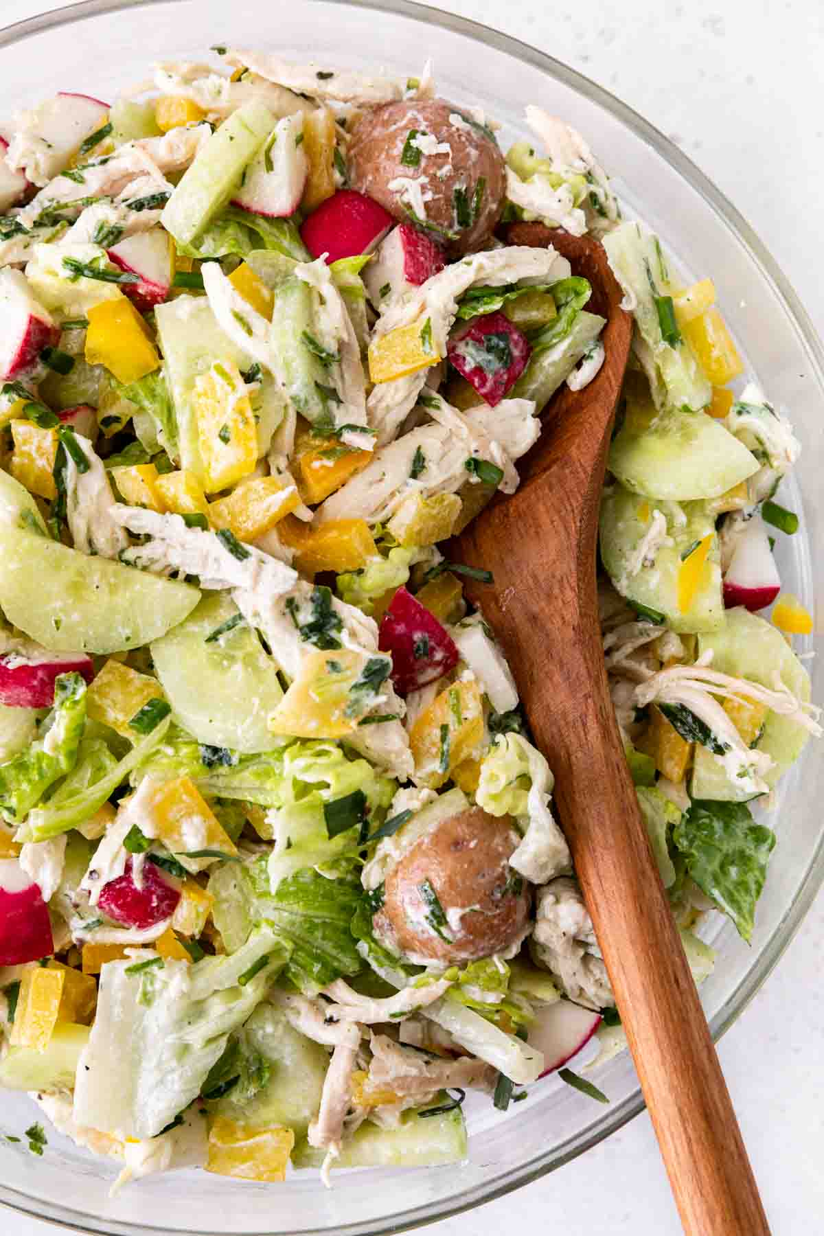 Spring Tarragon Chicken Salad  in a bowl with wooden serving spoon