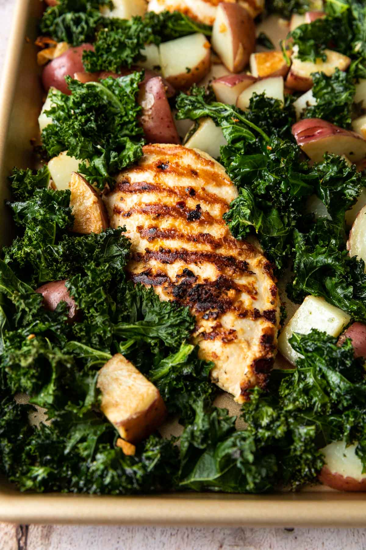 Sheet Pan Roasted Garlic Chicken with Kale and Potatoes on a sheet pan